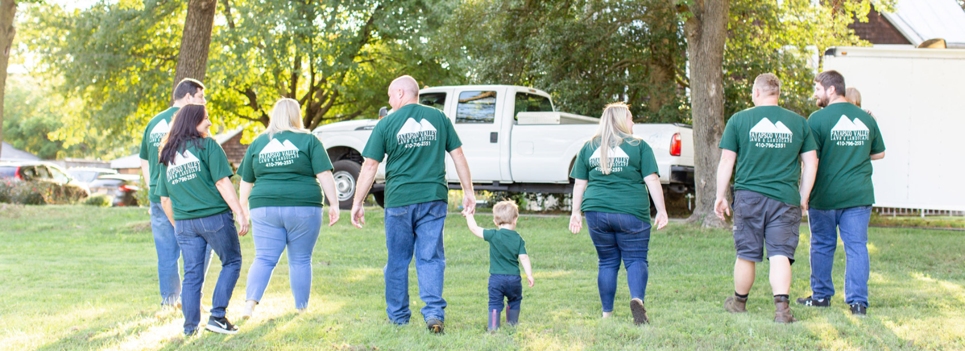 The family behind Patapsco Valley Lawn & Landscape walking away from the camera
